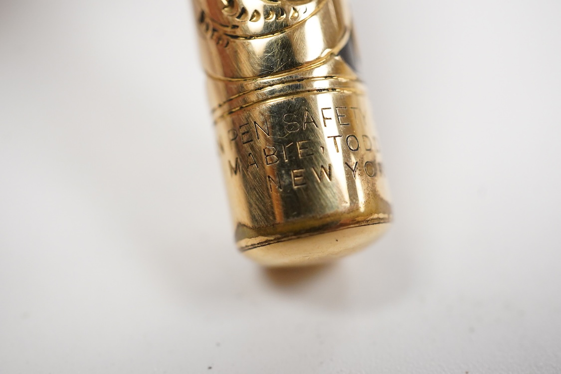 A Swan MT & Co. sterling silver filigree eyedropper along with similar gold filled example